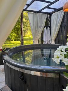 a gazebo with a table and a window at Gorczańska Chatka in Osobie