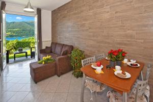 a living room with a table and a couch at Calla in Colico