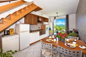 a kitchen with a wooden table and a dining room at Calla in Colico