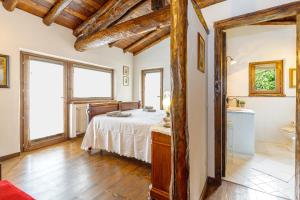 a bedroom with a bed and a bathroom at Villa Formaga Stunning View & Garden - Happy Rentals in Gargnano +31 photos