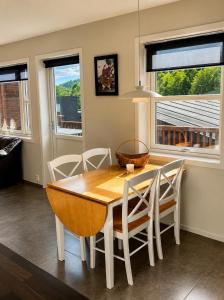 a dining room with a wooden table and chairs at Olavsberget camping in Porsgrunn