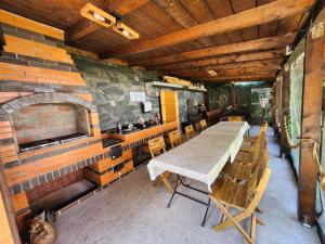 a table and chairs in a kitchen with a brick wall at Vila Agata in Sinaia +38 photos