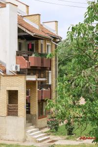 an external view of a brick building with balconies at Green Paradise in Vrnjačka Banja