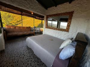 a bedroom with a bed and a large window at Savieza Life Experience in Nemocón