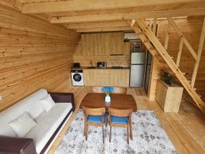 a living room with a couch and a table in a cabin at Machaxela Skyline in Tsʼkhemlisi