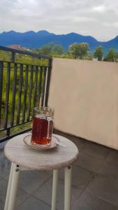 a glass of tea sitting on a table on a balcony at Villa Batu Iggy in Batu