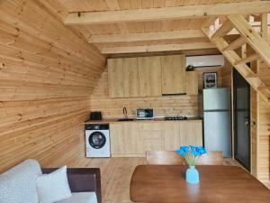 a kitchen with a table and a refrigerator in a room at Machaxela Skyline in Tsʼkhemlisi +12 photos