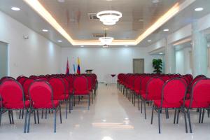 a row of red chairs in a room with flags at Hotel Medellín Rodadero in Santa Marta +55 photos