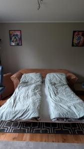 a bed with sheets on it in a bedroom at Cozy pet-friendly apartment with parking in Flekkefjord