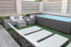 a patio with a swimming pool and chairs and a table at Cridima Luxury - Villa Hera in Santa Maria La Carità