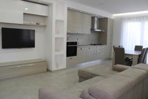 a large living room with a couch and a kitchen at Cridima Luxury - Villa Hera in Santa Maria La Carità