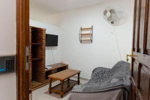 a bedroom with a bed and a desk and a chair at Hospedaje Lisboa Algeciras P Ca 0214 y A Ca 0232 in Algeciras