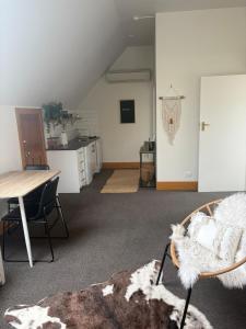 a living room with a table and a kitchen at Spacious 1 Bed apartment City centre in Palmerston North
