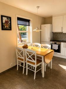 a kitchen with a dining room table and chairs at Olavsberget camping in Porsgrunn