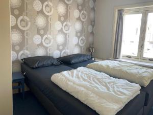 a bedroom with two beds and a window at Historic Cottage w Garden in Breskens +17 photos