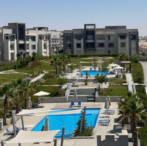 an aerial view of a resort with two pools at GAIA Penthouse in El Dab‘a