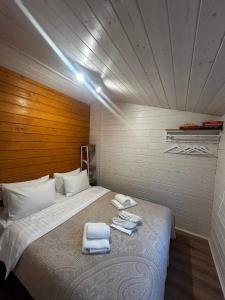 a bedroom with a large bed with towels on it at МріяТИ in Verkhovyna +71 photos