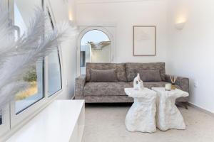 a living room with a couch and a table at Pyrgaki Hideout Beachfront Apartment in Agiassos