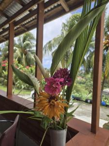 a vase filled with flowers sitting on a table at Island View Estate in Kingstown
