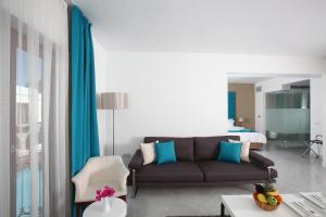 a living room with a couch and a bedroom at saraya otel in Bodrum City