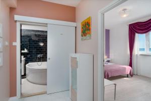a bathroom with a tub and a toilet in a room at Apartments Family Gligora in Mandre +62 photos