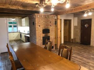 a dining room with a table and a brick fireplace at ALVORADA Mościce Dolne nad Bugiem in Nowosiółki +42 photos