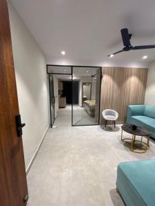 a living room with a blue couch and a table at Cloud Eleven House in Kharar