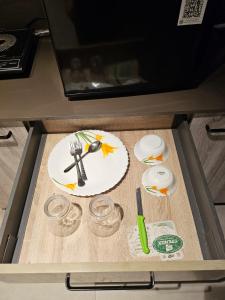 a plate with a fork and knife on a table at Cloud Eleven House in Kharar