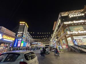 a busy city street at night with people riding motorcycles at Cloud Eleven House in Kharar