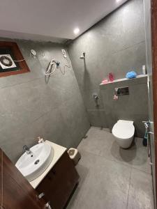 a bathroom with a white toilet and a sink at Cloud Eleven House in Kharar +12 photos