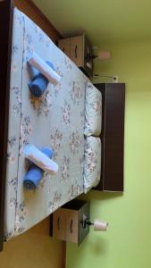 a bathroom with two blue towels on a shelf at Gezim guest house in Shirokë