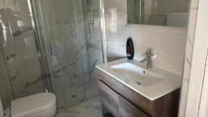 a bathroom with a sink and a shower at La maison Sophel in Pieris