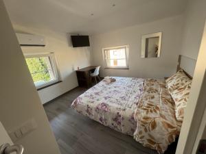 a bedroom with a bed and a desk in it at La maison Sophel in Pieris