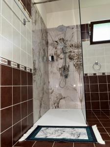 a bathroom with a shower with a toilet in it at Gezim guest house in Shirokë +41 photos