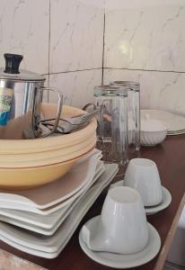 a table topped with plates and bowls and glasses at Chez Bryan in Avéméné
