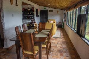 a dining room with a wooden table and chairs at Savieza Life Experience in Nemocón +38 photos