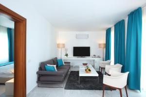a living room with a couch and a tv at saraya otel in Bodrum City