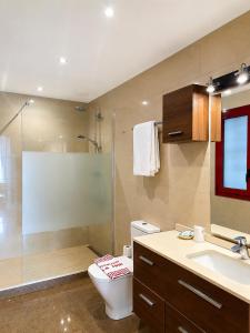a bathroom with a shower and a toilet and a sink at Hostal La Tina in Port de la Selva +17 photos