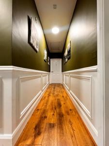 a hallway with wood floors and green walls at Ambassador House in Carrick on Shannon