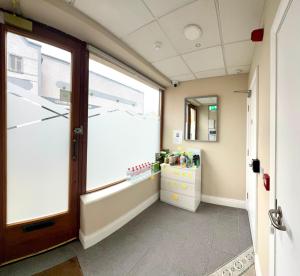 a room with a large window and a bathroom at Ambassador House in Carrick on Shannon