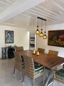 a dining room with a wooden table and chairs at Finca San Barbara in Pavas