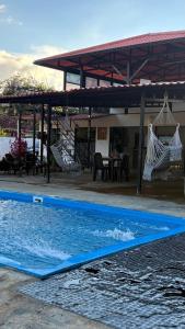 a blue surfboard laying on the ground in a swimming pool at Finca San Barbara in Pavas