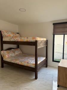 two bunk beds in a room with a window at Finca San Barbara in Pavas +11 photos