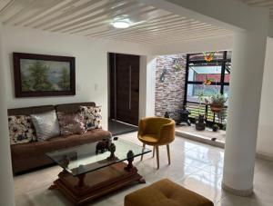 a living room with a couch and a chair at Finca San Barbara in Pavas