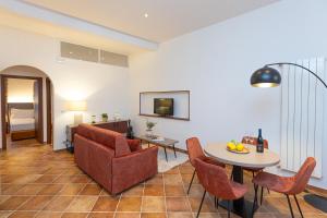 a living room with a couch and a table at Marta Lake Albergo Diffuso & Spa in Marta