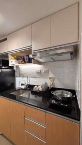 a kitchen with a sink and a counter top at Ciao Vacanza Staycation in San Fernando