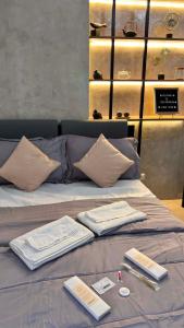 a bed with towels and books on top of it at Ciao Vacanza Staycation in San Fernando +49 photos