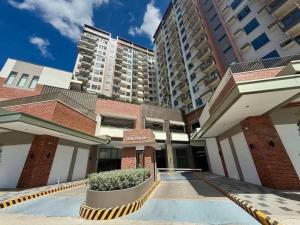 a building with a courtyard in front of some tall buildings at Ciao Vacanza Staycation in San Fernando