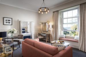 a living room with a couch and a table at Budock Vean Hotel and Spa in Falmouth