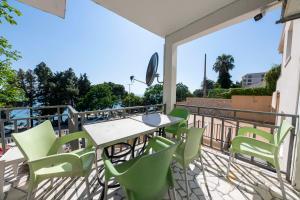 a patio with a table and chairs on a balcony at FIRST ROW Sea View in Šušanj